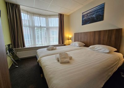 Tweepersoonskamer met 2 losse bedden zicht bij binnenkomst - Hotel Eckhardt Uithuizen